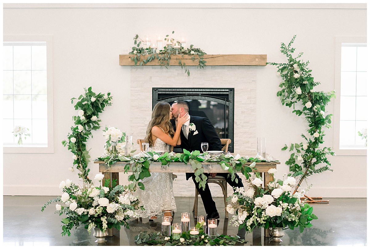 Bride and groom kiss at reception