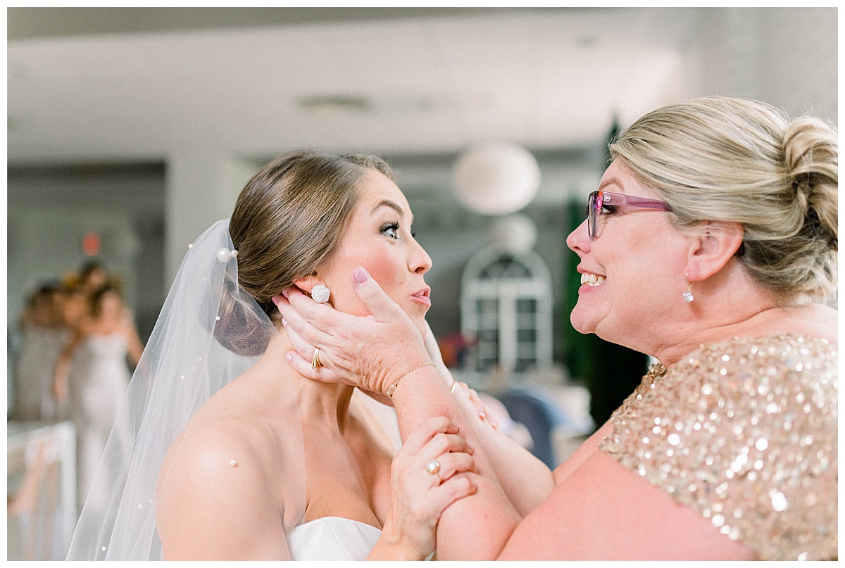 Mom and bride laughing at wedding
