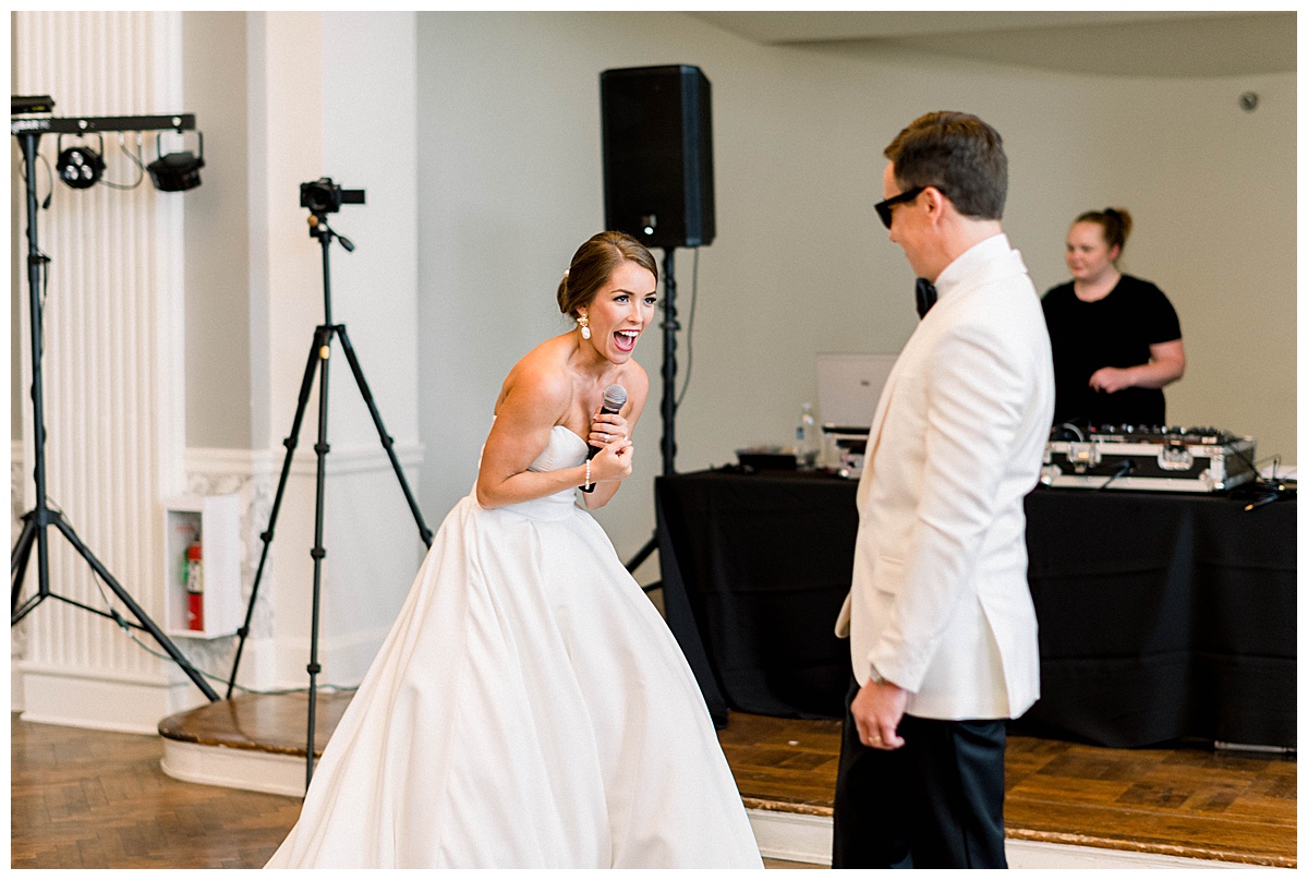 Bride laughing into microphone